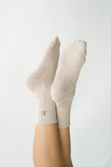 close-up of the grip dots on the sole of the taupe pilates sock